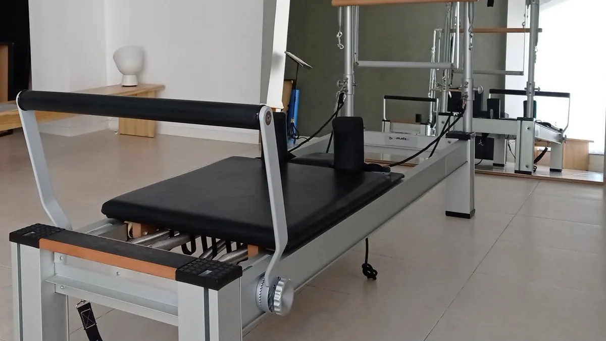 Reformer con su carro tapizado, la barra de pies y los muelles a la vista